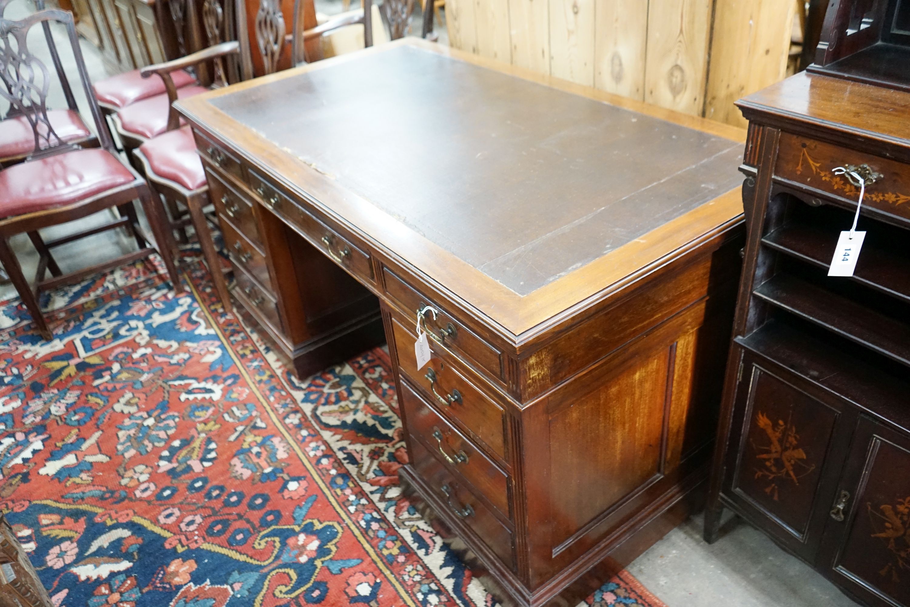 A reproduction Georgian style mahogany twin pedestal desk, fitted nine short drawers, on plinth base, width 152cm, depth 83cm, height 76cm